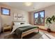 Bright bedroom with scenic views, featuring a comfortable bed and minimalist decor for a serene atmosphere at 10370 Grande Vista Ct, Lone Tree, CO 80124