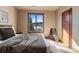 Bedroom featuring natural light, a plush bed, and a view of snow-covered trees at 10370 Grande Vista Ct, Lone Tree, CO 80124