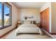 Bedroom with a plush bed, minimalist decor, and a large window showcasing mountain views at 10370 Grande Vista Ct, Lone Tree, CO 80124