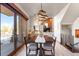 Dining area with modern chandelier, fireplace and sliding doors to deck at 10370 Grande Vista Ct, Lone Tree, CO 80124