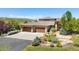 Stunning home with a three-car garage, well-manicured landscaping, and a stone facade at 10370 Grande Vista Ct, Lone Tree, CO 80124