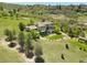 Expansive backyard with covered patio, a stone fireplace, and lush landscaping at 10370 Grande Vista Ct, Lone Tree, CO 80124