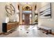 Welcoming foyer with tile flooring, a stylish chandelier, and a decorative bench at 10370 Grande Vista Ct, Lone Tree, CO 80124