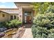 Inviting stone-accented front entrance with a water feature and lush landscaping at 10370 Grande Vista Ct, Lone Tree, CO 80124