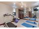 Bright gym with a mirrored wall, treadmill, fitness mats, and exercise balls at 10370 Grande Vista Ct, Lone Tree, CO 80124