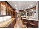 Open kitchen with custom wood cabinets, and bar seating at 10370 Grande Vista Ct, Lone Tree, CO 80124