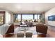 Cozy living room featuring large windows that offer scenic mountain views and great natural light at 10370 Grande Vista Ct, Lone Tree, CO 80124