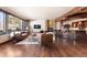The living room is adorned with hardwood floors, a stone fireplace, and comfortable leather seating at 10370 Grande Vista Ct, Lone Tree, CO 80124