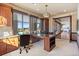 Bright office with a large desk, built-in cabinets, and large windows offering scenic views at 10370 Grande Vista Ct, Lone Tree, CO 80124
