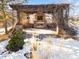 Outdoor living space with stone fireplace and natural surroundings at 10370 Grande Vista Ct, Lone Tree, CO 80124