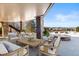 Covered patio area with an outdoor fire pit, stone columns, and mountain views at 10370 Grande Vista Ct, Lone Tree, CO 80124