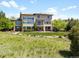 Expansive backyard with a stone patio and lush landscaping, offering a serene outdoor retreat with large windows at 10370 Grande Vista Ct, Lone Tree, CO 80124