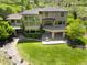 An elegant stone-clad home featuring large windows and an outdoor living area with a fire pit, perfect for entertaining guests at 10370 Grande Vista Ct, Lone Tree, CO 80124