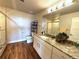Well-lit bathroom featuring a granite countertop vanity and a glass-enclosed shower with decorative tiles at 3125 Red Kit Rd, Franktown, CO 80116