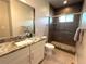 Modern bathroom featuring a granite countertop vanity, modern shower, and tiled floors at 3125 Red Kit Rd, Franktown, CO 80116