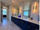 Elegant bathroom with double vanity, modern fixtures, and a soaking tub with views at 3125 Red Kit Rd, Franktown, CO 80116