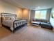 Comfortable bedroom featuring a cozy bed, a sitting area, and a view of the outdoors at 3125 Red Kit Rd, Franktown, CO 80116