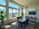 Bright dining room with large windows, modern chandelier, and comfortable seating for eight at 3125 Red Kit Rd, Franktown, CO 80116