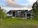 Striking front exterior with manicured lawn and contemporary architectural design details at 3125 Red Kit Rd, Franktown, CO 80116