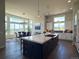 Bright, open kitchen featuring a center island with gas cooktop and an adjacent dining area with large windows at 3125 Red Kit Rd, Franktown, CO 80116
