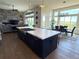 Stylish, modern kitchen with a large island, open to the living and dining areas, and scenic views at 3125 Red Kit Rd, Franktown, CO 80116