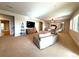 Spacious living room with neutral tones, plush seating, and large windows, offering a bright and inviting atmosphere at 3125 Red Kit Rd, Franktown, CO 80116