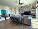Bright living room features a stacked stone fireplace, hardwood floors, and a stylish bar seating area at 3125 Red Kit Rd, Franktown, CO 80116