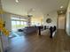 Open-concept living room with modern fireplace, balcony access, and seamless flow to the kitchen at 3125 Red Kit Rd, Franktown, CO 80116