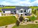 Aerial view of the home's backyard featuring a fire pit, trampoline, and lush landscaping at 3125 Red Kit Rd, Franktown, CO 80116