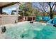 Backyard deck featuring a hot tub, outdoor seating, and lush green trees in the background at 978 Mercury Cir, Lone Tree, CO 80124