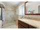 Updated bathroom featuring tiled shower with seat and decorative tile accents, plus granite vanity at 978 Mercury Cir, Lone Tree, CO 80124