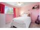 Pink bedroom with hardwood floors, guitar, and whimsical decor at 978 Mercury Cir, Lone Tree, CO 80124