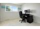 Home office with a black desk, computer, and a large window overlooking a tree at 978 Mercury Cir, Lone Tree, CO 80124