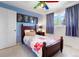 Cheerful bedroom with blue accent wall, ceiling fan, and window at 978 Mercury Cir, Lone Tree, CO 80124