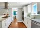 View of kitchen with stainless appliances and granite countertops, leading to dining room, and views to the entry at 978 Mercury Cir, Lone Tree, CO 80124