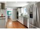 Updated kitchen with stainless refrigerator, double oven, and granite countertops leading to dining room at 978 Mercury Cir, Lone Tree, CO 80124