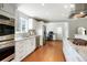 Updated kitchen features stainless steel appliances, white cabinets, and granite countertops, with adjacent desk area at 978 Mercury Cir, Lone Tree, CO 80124