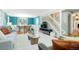 Beautiful living room and dining area with vibrant blue accent wall, hardwood floors, and bright staircase at 978 Mercury Cir, Lone Tree, CO 80124