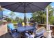 Inviting patio area with a table, chairs, and large umbrella, perfect for outdoor relaxation at 978 Mercury Cir, Lone Tree, CO 80124