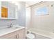 Bright bathroom with a modern sink, tiled walls, a window, and a bathtub-shower combination at 155 S Pennsylvania St # 311, Denver, CO 80209