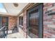 Brick exterior entryway with a grey framed screen door and a shelf with assorted items at 155 S Pennsylvania St # 311, Denver, CO 80209