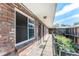 Brick apartment building corridor with windows and exterior access to each unit at 155 S Pennsylvania St # 311, Denver, CO 80209