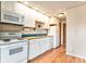 Well-equipped kitchen with white cabinets, appliances, butcher block countertops, and blue backsplash at 155 S Pennsylvania St # 311, Denver, CO 80209