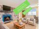 Cozy living room with brick fireplace, hardwood floors, and modern furniture at 155 S Pennsylvania St # 311, Denver, CO 80209