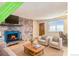 Inviting living room featuring a brick fireplace with a blue firebox and light hardwood flooring at 155 S Pennsylvania St # 311, Denver, CO 80209