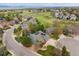 Stunning aerial view captures the property, lush landscaping, and neighborhood set against a backdrop of distant mountains at 10029 Winterthur Ct, Highlands Ranch, CO 80129