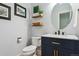 A stylish powder room features modern fixtures, art, and tasteful decor at 10029 Winterthur Ct, Highlands Ranch, CO 80129