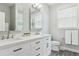Bathroom with double vanity, a large mirror, modern fixtures, and a window providing natural light at 10029 Winterthur Ct, Highlands Ranch, CO 80129