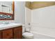 Bathroom features a white sink, vanity, toilet and tub with tiled walls at 10029 Winterthur Ct, Highlands Ranch, CO 80129