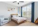 Bedroom features large windows with a chair, bed, curtains, and guitar at 10029 Winterthur Ct, Highlands Ranch, CO 80129